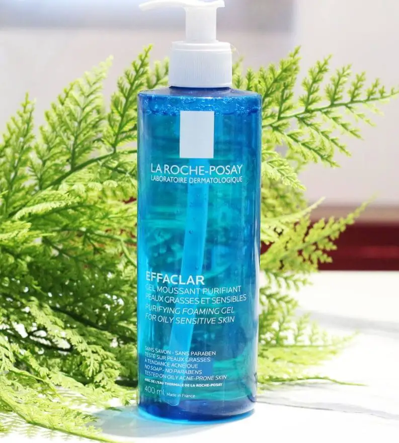 La Roche-Posay bottle of cleanser for oily skin on table with fern at back