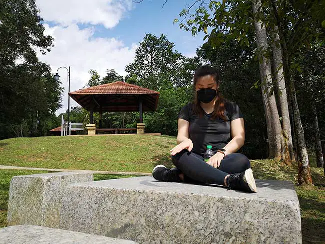 valerie mediting under the sun in the park