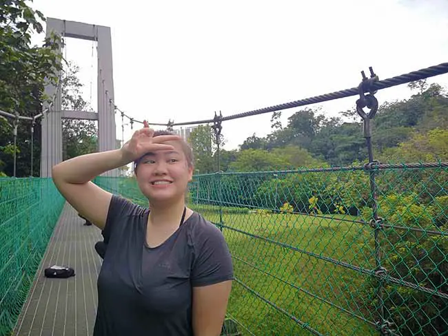 valerie posing on the bridge under the white clouds