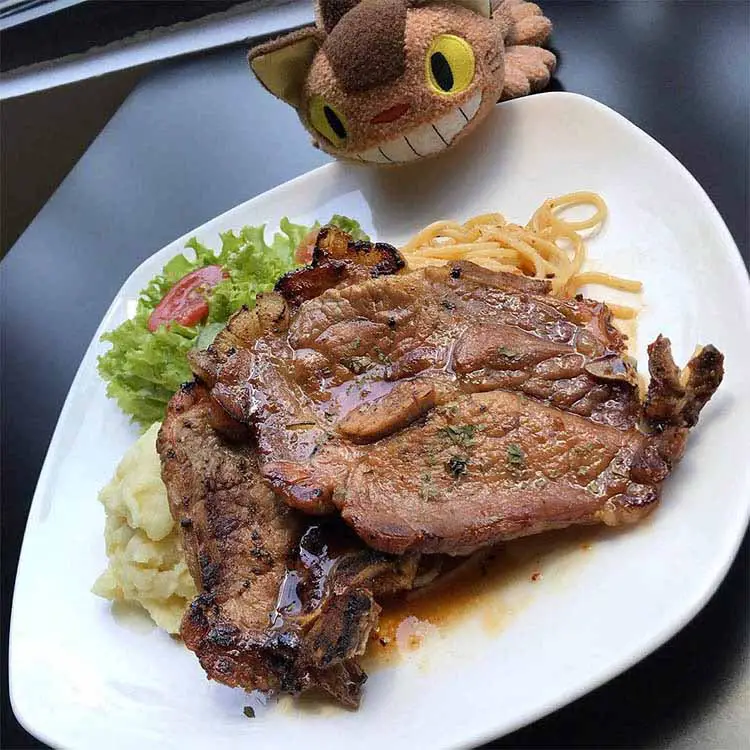 honey pork chop with aglio olio served in peekaboo cafe