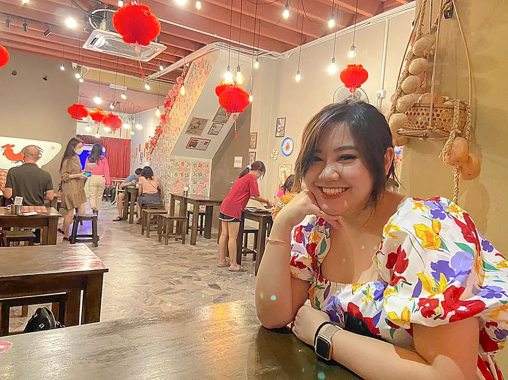 valerie smiling to the camera in a dessert shop in penang