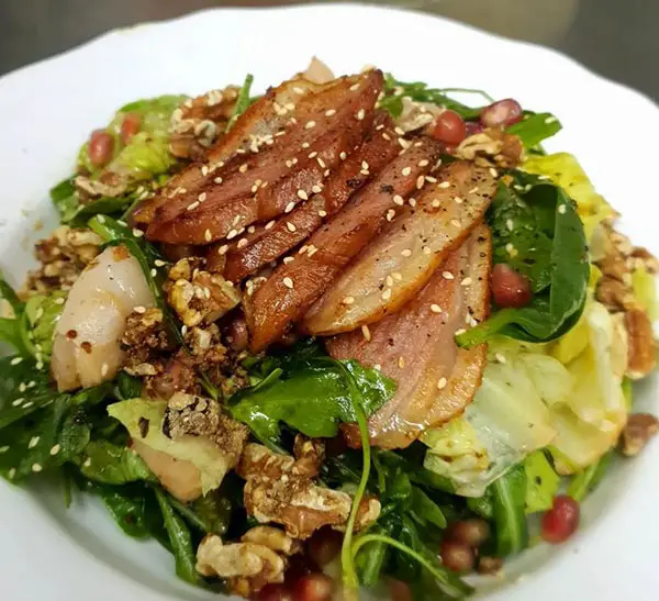 Smoky-slices-of-duck,-lychees-and-pomegranate-in-a-fresh-salad-tossed-in-honey-mustard-dressing-and-finished-with-candied-walnuts-by-the-front-room-and-kneady-bakery-cafe