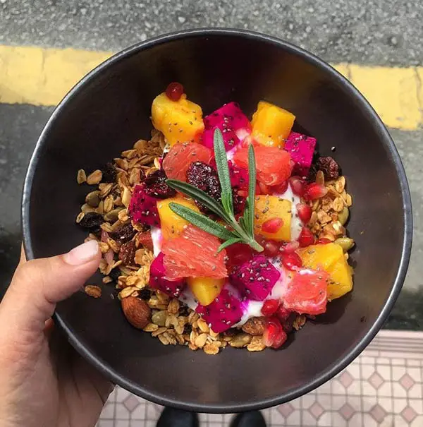 homemade granola with berries chia jam and assorted fresh fruits