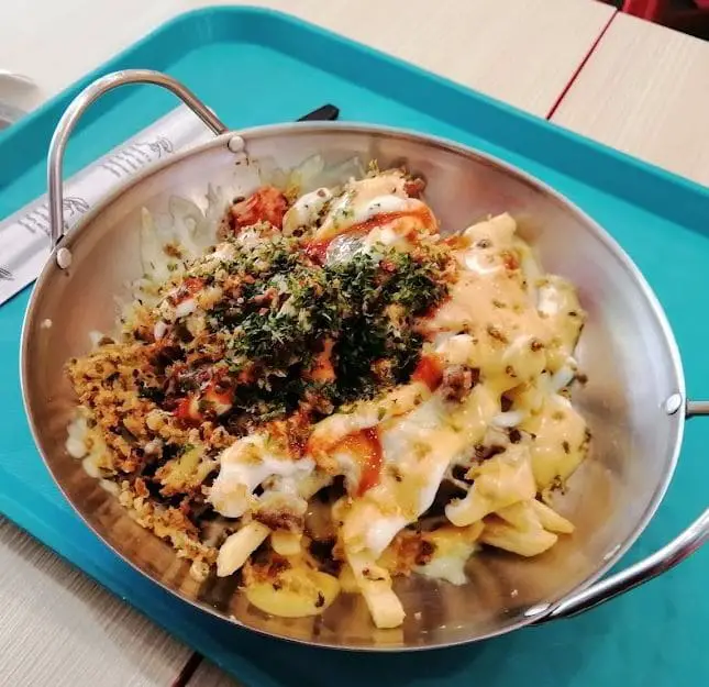 cheesy korean food in a mini wok served in jinjja