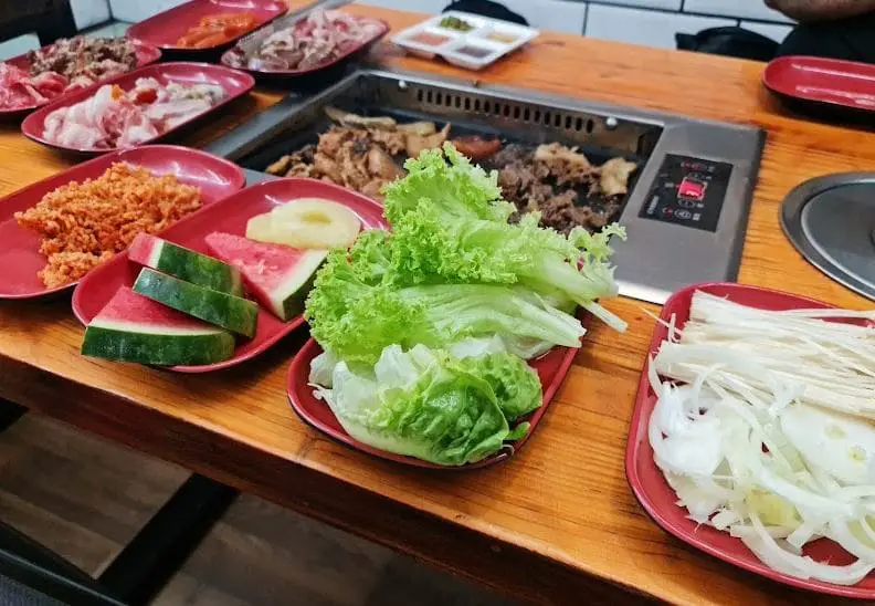 plates of dishes ready to grill in korean fusion bbq bugis