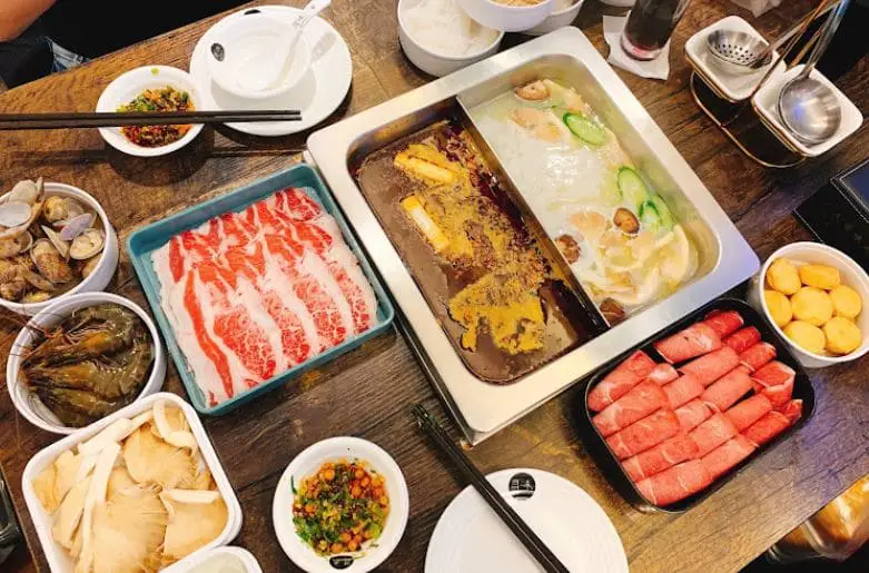 plethora of ingredients on the table of xun wei hotpot in bugis