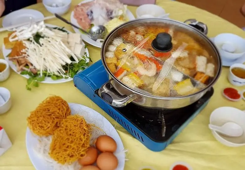 steamboat hot pot on the table with other ingredients