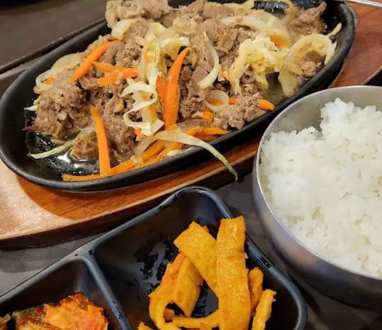 stir fry pork with side dishes in daebak korean restaurant