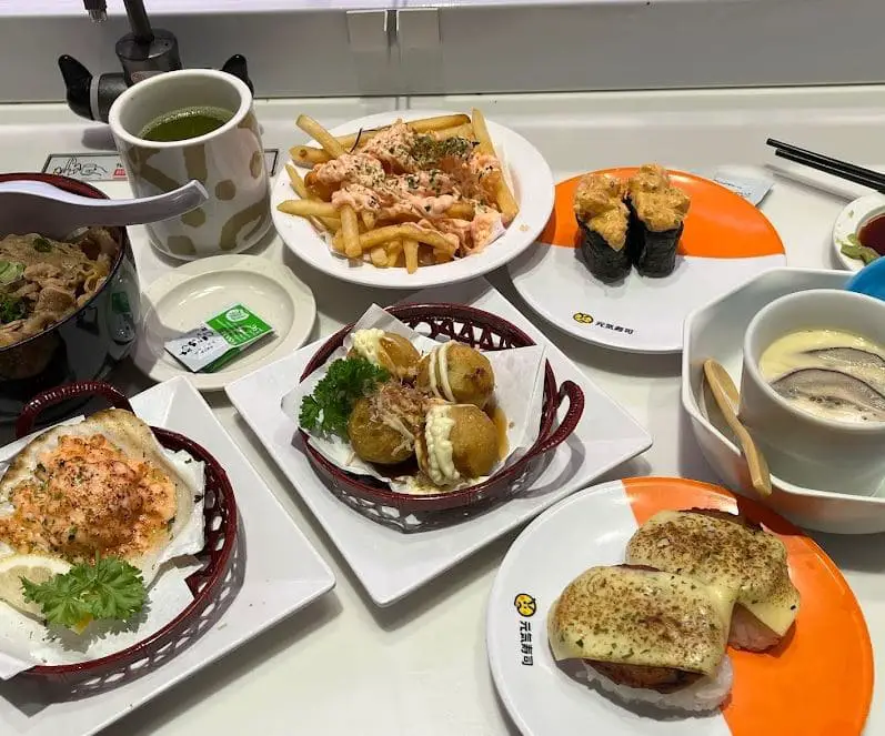variety of japanese food on the table served at genki sushi in bugis