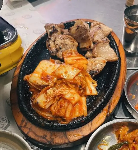 grilled meat and kimchi on a plate at singkoba