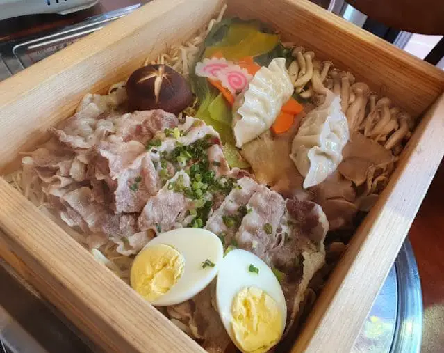 ingredients served in a wooden box at mimi korean kbbq restaurant