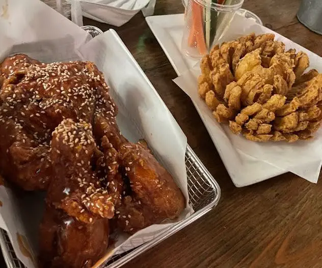 while fried chicken with sesame street and deep fried flower onion served at chicken up korean restaurant in tanjong pagar