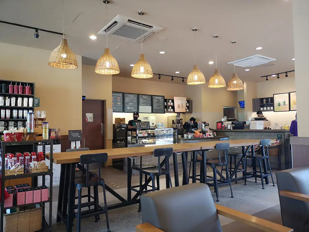 counter inside the starbucks with merchandise rack next to it