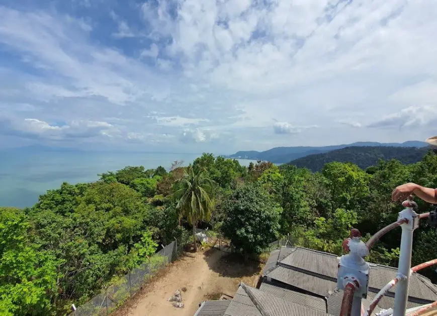 sea and green mountain view from muka head lighthouse near monkey beach in penang