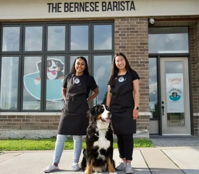 The Bernese Barista lining up with dog in front of the cafe for a photograph