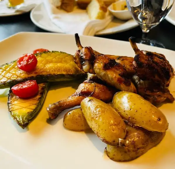 half chicken and potatoes cooked in italian style at Via Allegro Ristorante