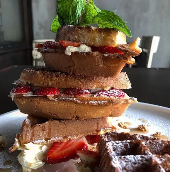 stacked strawberry waffles served at Otherwise Cafe