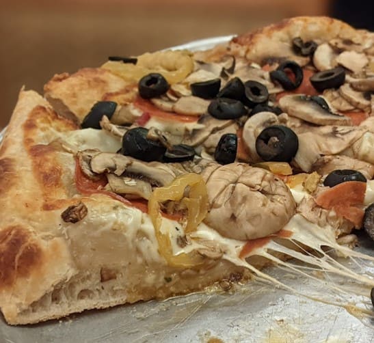thick loaded cheesy pizza from Maccheroni Cucina Alfresco