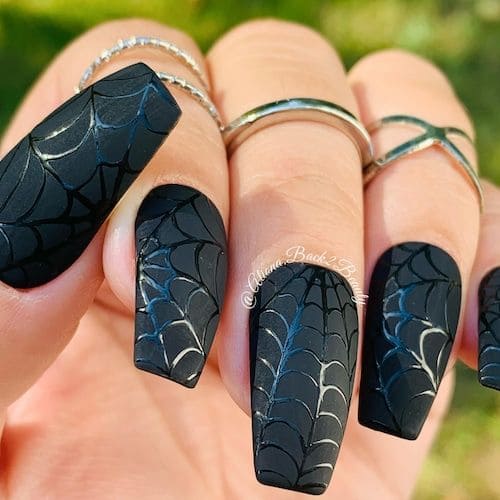 black spiderman themed nail art