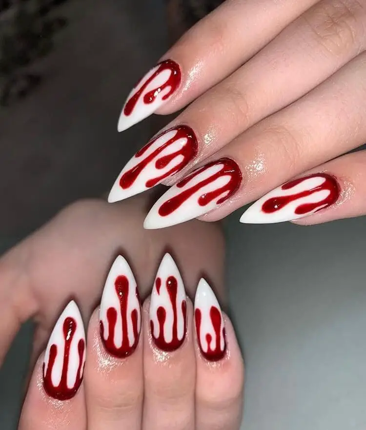 dripping red blood on end of white nails
