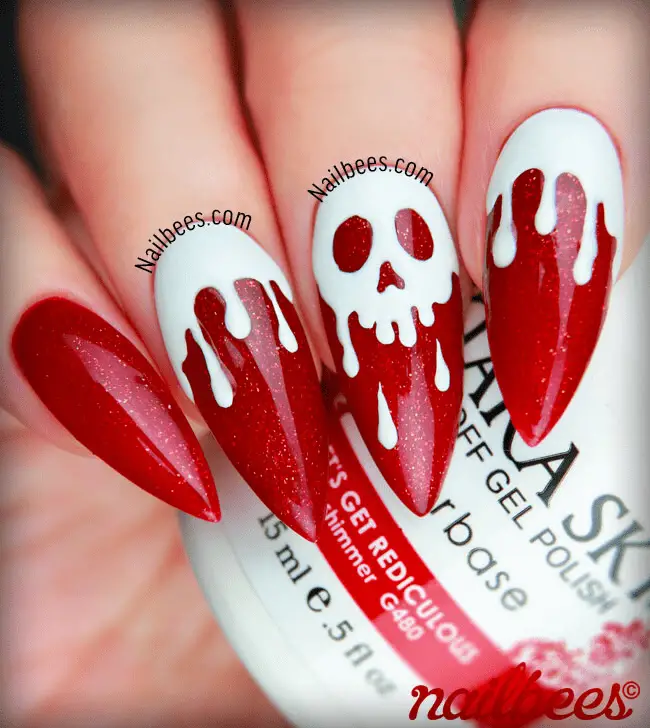 dripping white skull in red nails