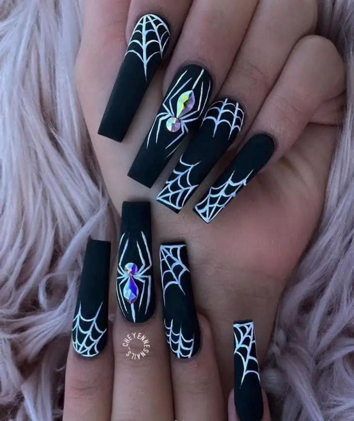glowing white spider and web on black nails