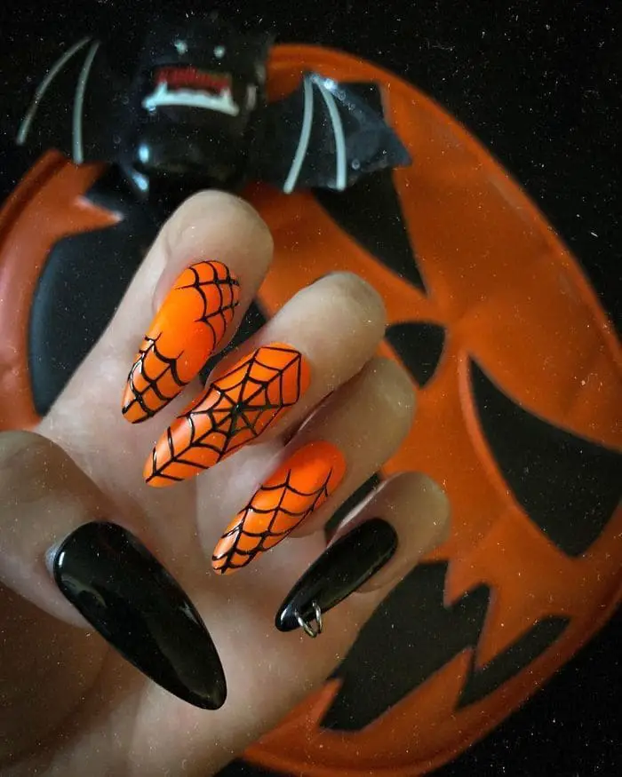 orange spider web and dark nails