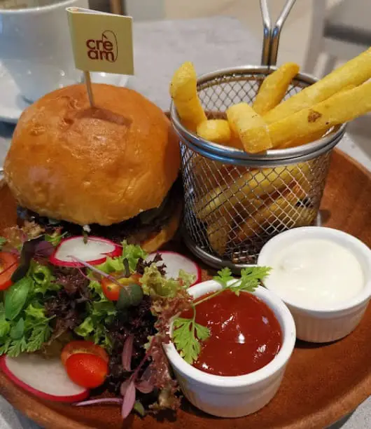 burger fries and salad from cream cafe