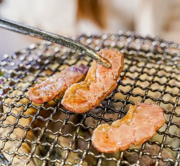 tasty meat being grilled at KANNICHIKAN YAKINIKU